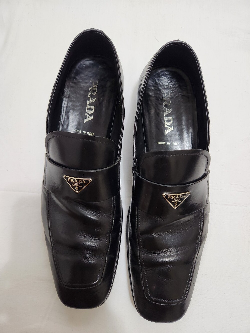 Prada Black Leather Slip-On Loafers with Silver Triangle Logo